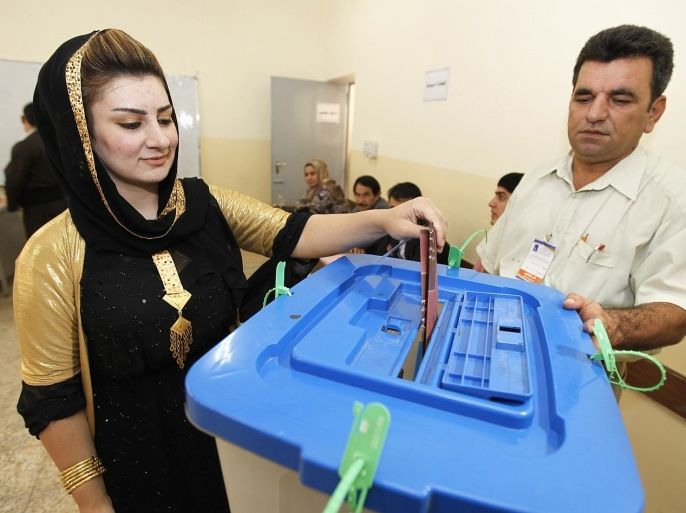 An Iraqi Kurd woman casts her vote into a ballot box during regional parliamentary elections at a polling station in Arbil, capital of the autonomous Kurdistan region, about 350 km (217 miles) north of Baghdad, September 21, 2013. Kurds went to the polls on Saturday to elect a new parliament in an election that is being dubbed as the most crucial in the history of Iraqi Kurdish political powers, with potential to change the political structure of the next parliament and government cabinet. About 1,129 candidates representing 32 political entities are competing for 100 parliamentary seats. Other nominees representing Christian, Turkmen and Armenian minorities in the region are competing for 11 additional seats.