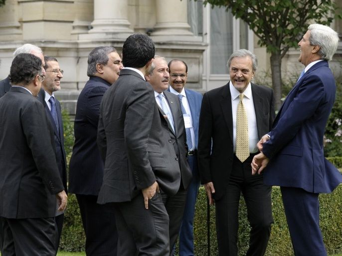 U.S. Secretary of State John Kerry (R) shares a laugh as he talks with members of the Arab League Peace Initiative following their meeting at the U.S. Embassy in Paris September 8, 2013.