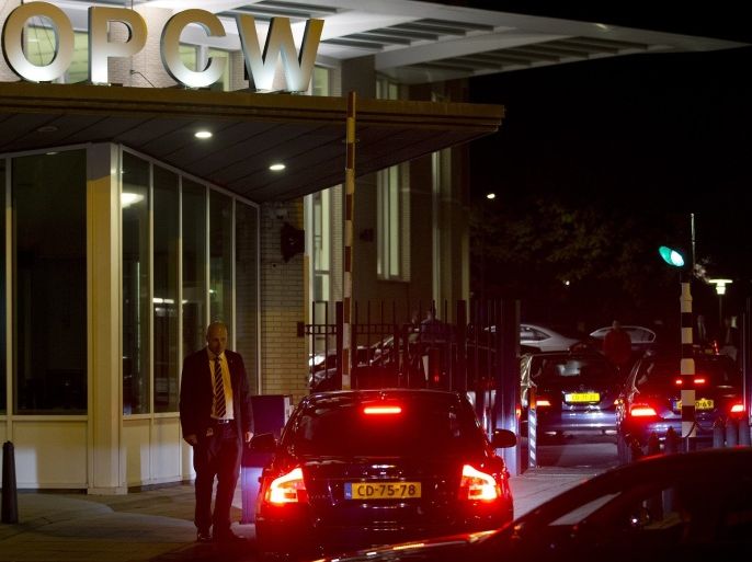 Cars arrive at the headquarters of the Organization for the Prohibition of Chemical Weapons, OPCW, in The Hague, Netherlands, Friday Sept. 27, 2013. The global chemical weapons watchdog has scheduled a meeting to approve a U.S.-Russian brokered plan to rapidly verify, secure and then destroy Syria's arsenal of poison gas and nerve agents. The 41-nation executive council of the OPCW is meeting late Friday to sign off on the plan that has been hammered out in nearly two weeks of behind-closed doors negotiations.