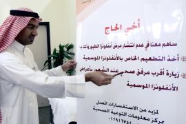 Saudi director of the health control centre at King Abdul Aziz airport, doctor Mohammed al-Harthi points to a health warning against avian flu and and influenza for hajj pilgrims, in Jeddah, 28 December 2005. Saudi authorities are working hard to ensure Muslim pilgrims flocking to join the annual pilgrimage to Mecca are disease-free and pose no threat to the oil-rich kingdom's security. Special measures have been implemented to deal with pilgrims coming from Africa, the Indian subcontinent and countries like Egypt and Yemen where infectious diseases such as cholera and meningitis are common.