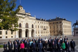 Russia's President Vladimir Putin, center foreground, stands with G-20 leaders during a group photo outside of the Konstantin Palace in St. Petersburg, Russia on Friday, Sept. 6, 2013. World leaders are discussing Syria's civil war at the summit but look no closer to agreeing on international military intervention to stop it.