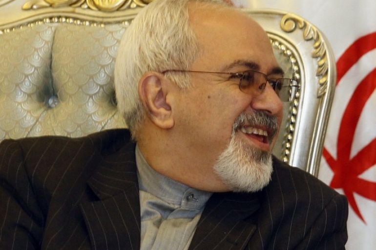 Iran's Foreign Minister Mohammed Javad Zarif speaks to his Iraqi counterpart Hoshyar Zebari, not seen, after arriving at the Baghdad International Airport, Iraq, Sunday, Sept. 8, 2013. Iran's new foreign minister has arrived in neighboring Iraq on his first trip abroad since taking office.