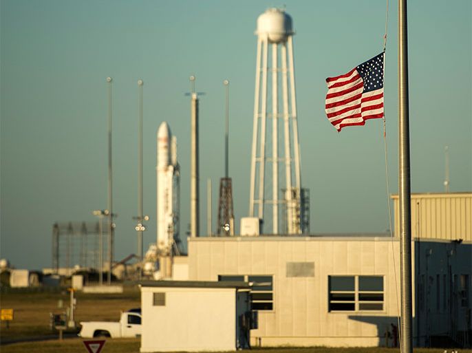 A handout picture released by NASA shows ta United States flag being flown at half-staff just outside the Mid-Atlantic Regional Spaceport (MARS) Pad-0A with the Orbital Sciences Corporation Antares rocket at NASA Wallops Flight Facility, Virginia, USA, 17 September 2013. US President Barack Obama directed on 17 September that flags be lowered to half-staff to pay tribute to the victims of 'the senseless acts of violence' perpetrated at the Washington Navy Yard. NASA's commercial space partner, Orbital Sciences Corporation, is targeting a 18 September launch of the Cygnus cargo spacecraft, demonstration cargo resupply mission, to the International Space Station. EPA/BILL INGALLS / NASA / HANDOUT HANDOUT EDITORIAL USE ONLY