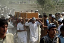 Afghan men carry the coffin of a civilian, allegedly killed in a NATO air strike, on the outskirts of Jalalabad in Nangarhar province on October 5, 2013. At least five civilians, including three children, were killed overnight in a NATO airstrike in eastern Afghanistan, officials said. The civilians, aged between 12 and 20, were killed while they were out hunting birds in the area of Saracha, a few kilometres from Jalalabad city, the capital of eastern Nangarhar province, provincial police spokesman Hazrat Hussain Mashreqiwal told AFP. AFP PHOTO/ Noorullah SHIRZADA