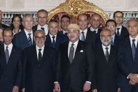 A handout picture released by the Moroccan Royal Palace shows Morocco's King Mohammed VI (C) posing with ministers of his newly appointed government on October 10, 2013 at the Royal Palace in Rabat. King Mohamed VI appointed a new Islamist-led government today ending a months-long crisis triggered by the defection of a key coalition partner, a minister told AFP. AFP PHOTO / HO/MOROCCAN ROYAL PALACE - RESTRICTED TO EDITORIAL USE - MANDATORY CREDIT "AFP PHOTO