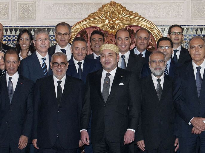 A handout picture released by the Moroccan Royal Palace shows Morocco's King Mohammed VI (C) posing with ministers of his newly appointed government on October 10, 2013 at the Royal Palace in Rabat. King Mohamed VI appointed a new Islamist-led government today ending a months-long crisis triggered by the defection of a key coalition partner, a minister told AFP. AFP PHOTO / HO/MOROCCAN ROYAL PALACE - RESTRICTED TO EDITORIAL USE - MANDATORY CREDIT "AFP PHOTO