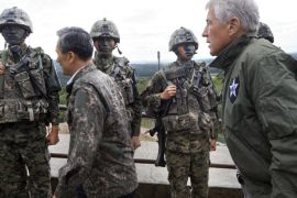 ANMUNJOM, SOUTH KOREA - SEPTEMBER 30: U.S. Secretary of Defense Chuck Hagel, right, walks past South Korean soldiers with South Korean Defense Minister Kim Kwan-jin, left, during a tour of the Demilitarized Zone (DMZ), the military border separating the two Koreas, on September 30, 2013 in Panmunjom, South Korea. Hagel is expected to spend time in South Korea for celebrations marking the 60th anniversary of the ending of the Korean War before heading to Japan for ministerial meetings.