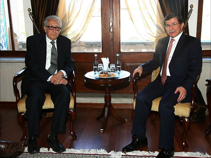 Turkish Foreign Minister Ahmet Davutoglu (R) poses with UN-Arab League mediator for Syria Lakhdar Brahimi on October 25, 2013 before their meeting in Ankara. AFP PHOTO / ADEM ALTAN