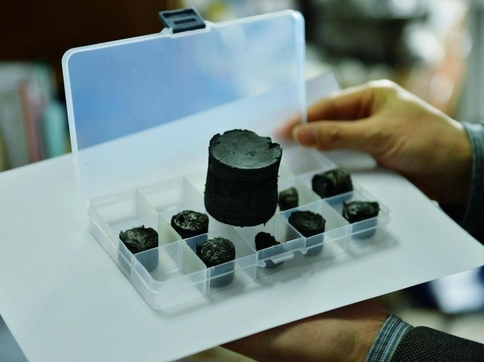 A researcher shows samples of graphene aerogel developed in a lab at Zhejiang University in Hangzhou in east China's Zhejiang province, 19 March 2013. The sponge-like matter weighs only 0.16 milligrams per cubic centimeter, and is the world's lightest solid material, about twice the density of hydrogen and less than helium. EPA/LONG WEI CHINA OUT