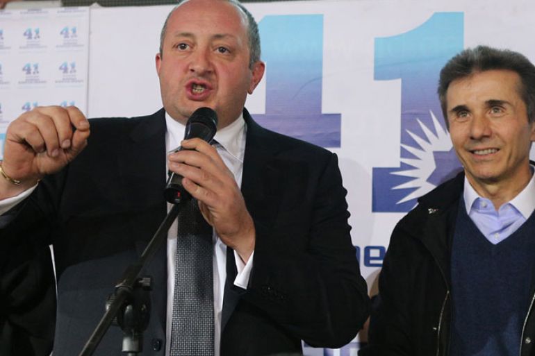 Presidential candidate Giorgi Margvelashvili (L) speaks as Georgian Prime Minister Bidzina Ivanishvili looks on as they celebrate at the Georgian Dream coalition's headquarters in Tbilisi, on October 27, 2013. A close ally of billionaire Georgian Prime Minister Bidzina Ivanishvili was on course to win a crushing victory at presidential polls on October 27, 2013 in the post-Soviet country, partial results from the electoral commission showed. Giorgi Margvelashvili -- from Ivanishvili's Georgian Dream coalition -- was on 63.8 percent of the vote with some 12 percent of polling stations counted, the electoral commission said, with challenger David Bakradze from outgoing president Mikheil Saakashvili's United National Movement party, back on 21.3 percent. AFP PHOTO