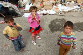 Syrian refugee children stand near their makeshift tents in central Ankara on October 12, 2013.