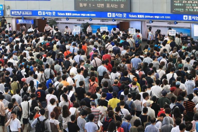 People wait in long queues to buy train tickets for their hometowns during the upcoming nation's biggest traditional holiday, Chusok, the Korean version of Thanksgiving Day, at Seoul Railway Station in Seoul, South Korea, Wednesday, Aug. 28, 2013. The government expects the number of hometown visitors and holidaymakers during the five-day, Sept. 18-22 holiday will exceed 35 million.