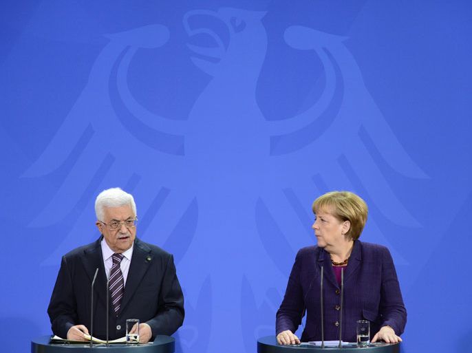 Berlin, GERMANY : German Chancellor Angela Merkel and Palestinian president Mahmud Abbas give a joint press conference on October 18, 12013 at the Chancellery in Berlin. Abbas, who actually tours Europe, is also to meet the German President and the German Foreign Minister later on the day. AFP PHOTO / JOHN MACDOUGALL