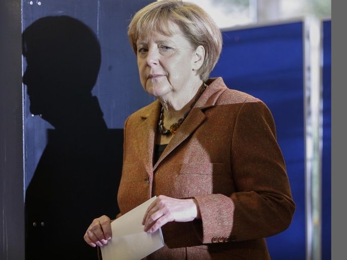 German Chancellor Angela Merkel, chairwoman of the Christian Democratic party CDU, leaves her voting booth to cast her vote in Berlin, Sunday, Sept. 22, 2013. 62 million voters in Germany are entitled to elect a new parliament as Merkel runs for her third term as chancellor.
