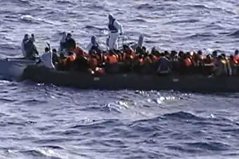 This picture grabbed on a video released by the Italian Navy on October 13, 2013 shows immigrants aboard a raft while being rescued from the sea by crew members of a naval vessel, off the Italian island of Lampedusa. Humanitarian agencies say nearly 20,000 migrants have perished while trying to cross the Mediterranean Sea into Europe over the past 20 years. Some 30,000 migrants have landed in Italy this year -- four times more than in 2012 -- many of them fleeing dictatorship in Eritrea.