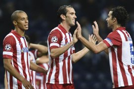 Atletico's defender Diego Godin (C) celebrate with his teammates their 2-1 victory after the Champions League group G football match FC Porto vs Atletico Madrid at Dragao Stadium in Porto on October 1, 2013. AFP PHOTO/ FRANCISCO LEONG