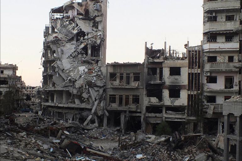 A general view shows buildings damaged by what activists said was shelling by forces loyal to Syria's President Bashar al-Assad in the besieged area of Homs October 19, 2013. REUTERS/Yazan Homsy (SYRIA - Tags: CONFLICT)