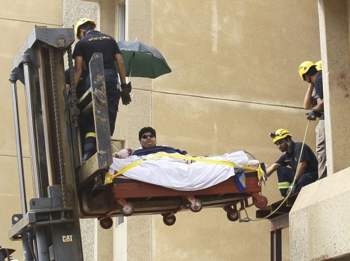 Saudi Civil Defence members use a forklift to move Khaled Mohsen Shaeri, 20, from his house in the Saudi city of Jizan, and to be airlifted to the capital Riyadh for medical treatment, August 19, 2013. Shaeri weighs approximately 610 kg (1345 lbs) and is suffering from severe obesity due to health problems that have resulted in a rapid increase in his weight over the past two years.