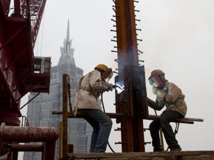 Workers labor on the Shanghai Center Tower under construction in Pudong, Shanghai Tuesday May 15, 2012. China's economic growth has abruptly decelerated from overheated to slower than Beijing wanted in just half a year as export demand and consumer spending at home weaken, raising the threat of job losses and possible unrest. (AP Photo) CHINA OUT.