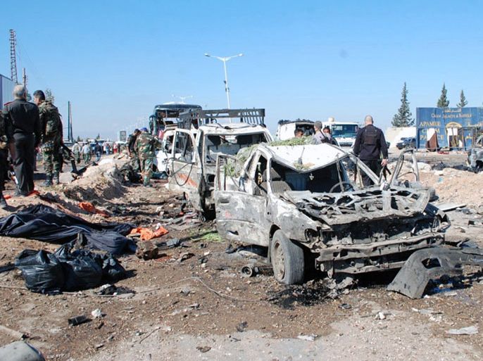 LOU945 - Damascus, -, SYRIA : A handout picture released by the official Syrian Arab News Agency (SANA) on October 20, 2013 allegedly shows soldiers inspecting the site of a car bomb attack in the government-held city of Hama in central Syria. "A violent explosion shook the Sinaa highway in Hama city, followed by intense gunfire" the Syrian Observatory for Human Rights said. "Several people were killed or wounded" reported state television. AFP PHOTO/SANA