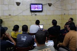 Egyptians watch the first episode of a show by Egypt's most prominent television satirist, Bassem Youssef, called "Al-Bernameg" (The Programme) in Cairo October 25, 2013. Youssef, known for his fierce jabs at ousted Islamist president Mohamed Mursi, returned to the airwaves on Friday following a summer break, poking equal fun at the fan frenzy surrounding Egypt's defense minister that has gripped the nation in recent months. Youssef rose to fame with a satirical online show after the uprising that swept Hosni Mubarak from power in 2011. REUTERS/Mohamed Abd El Ghany (EGYPT - Tags: POLITICS ENTERTAINMENT)