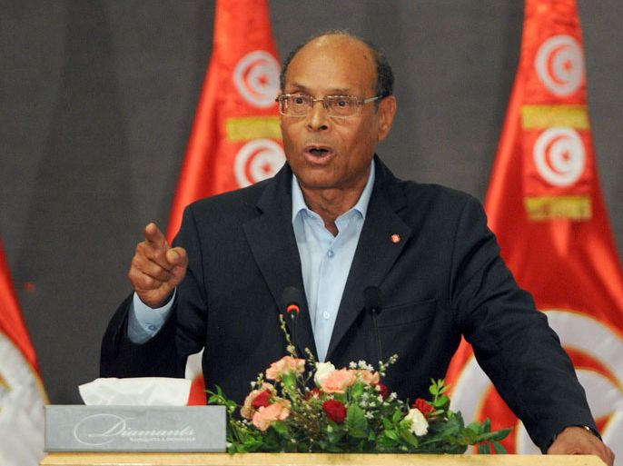 Tunisian President Moncef Marzouki speaks during a meeting as part of the dialogue between Tunisia's ruling Islamists and the opposition aimed at ending a two-month crisis on October 5, 2013 at the Palais des Congres in Tunis. Tunisia's ruling Islamist Ennahda party and the opposition signed a roadmap for the creation of a government of independents within three weeks. AFP PHOTO FETHI BELAID