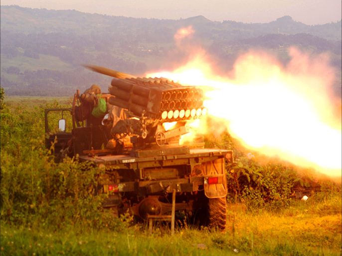 Rockets are fired from a Congolese army vehicle in the direction of M23 rebels in Kibumba, north of Goma October 27, 2013. REUTERS/Kenny Katombe (DEMOCRATIC REPUBLIC OF CONGO - Tags: MILITARY POLITICS CIVIL UNREST CONFLICT)