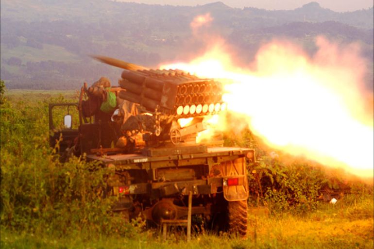 Rockets are fired from a Congolese army vehicle in the direction of M23 rebels in Kibumba, north of Goma October 27, 2013. REUTERS/Kenny Katombe (DEMOCRATIC REPUBLIC OF CONGO - Tags: MILITARY POLITICS CIVIL UNREST CONFLICT)