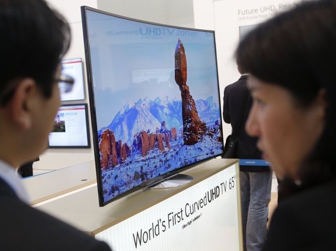 People look at the world's first curved UHD TV 55" 4K screen at the booth of Samsung during a media preview day at the IFA consumer electronics fair in Berlin, in this September 5, 2013 file photo. Chinese flat screen makers, once dismissed as second-class players in the global LCD market, are drawing envious looks from big names such as LG Display Co Ltd and Samsung. While the Korean giants were busy developing next-generation organic light emitting diode (OLED) TVs, little-known Chinese companies have started selling a type of display that are sharper than the standard LCD and cheaper than OLED.