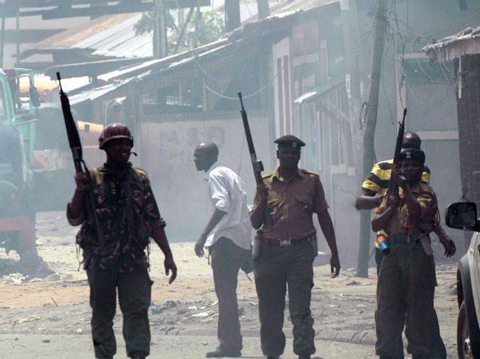 Kenyan security forces take position during riots sparked by the killing of a Muslim cleric in the port city of Mombasa on October 4, 2013. Rioters set fire to a church in Mombasa, in furious battles with the police sparked by the killing of Sheikh Ibrahim Ismail, police said. Witnesses said one protestor was shot and wounded, as armed paramilitary police moved towards a mosque, whose leaders have been accused of links to Somalia's Islamist Shebab, insurgents who attacked a Nairobi shopping mall last month. AFP PHOTO/STR