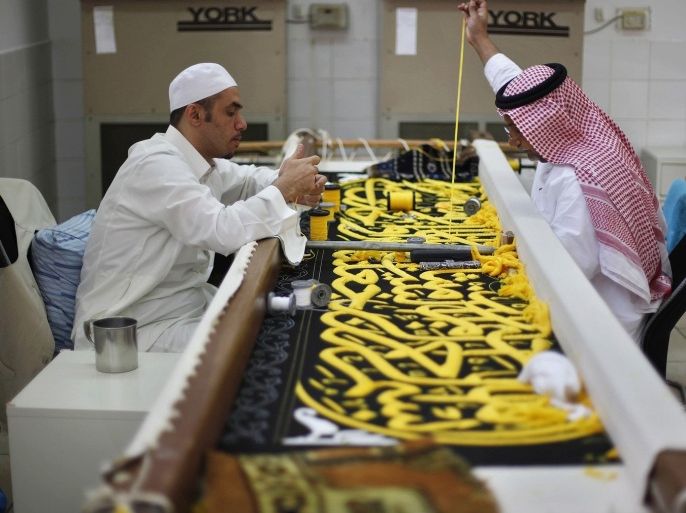 Workers embroider the Kiswa, a silk cloth covering the Holy Kaaba, in the holy city of Mecca, ahead of the annual hajj pilgrimage October 8, 2013. The Kaaba is Islam's holiest site.