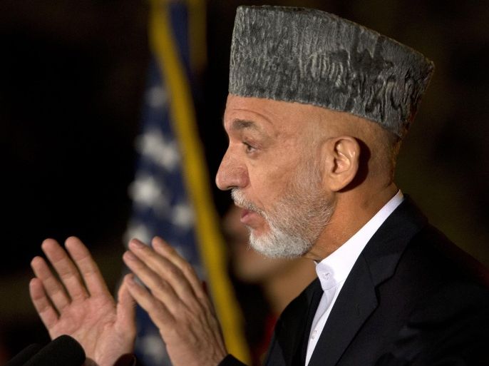 In this photograph taken on October 12, 2013, Afghan President Hamid Karzai gestures as he speaks during a news conference with US Secretary of State John Kerry at the Presidential Palace during an unannounced stop in Kabul, as a deadline approaches for a security deal about the future of US troops in the country. A long-delayed security deal on the future of US forces in Afghanistan is close to being completed, officials said October 13, after marathon talks in Kabul between President Hamid Karzai and US Secretary of State John Kerry.
