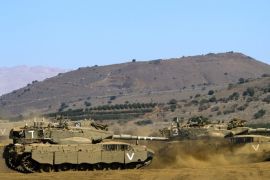 Israeli Merkava tanks roll in a training field in the Golan Heights, next to the Israeli-Syrian border, on October 10, 2013. The Israeli army fired on October 9, a Tammuz missile across the Syrian border in response to mortar fire from the Syrian at an Israeli military base in the northern Israeli-annexed Golan Heights leaving two soldiers with light wounds.