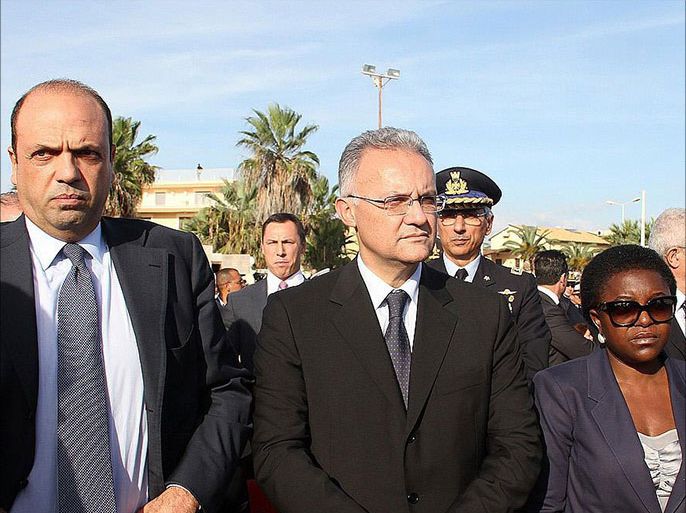 epa03918417 (L-R) Italian Interior Minister Angelino Alfano, Italian Defence Minister Mario Mauro and Italian Integration Minister Cecile Kyenge attend a ceremony commemorating the migrants who drowned off the southern Italian island of Lampedusa in Agrigento, Sicily island, Italy, 21 October 2013. The ceremony was organized to commemorate two deadly shipwrecks, which happened on October 3 and October 11. EPA/MONTANA LAMPO