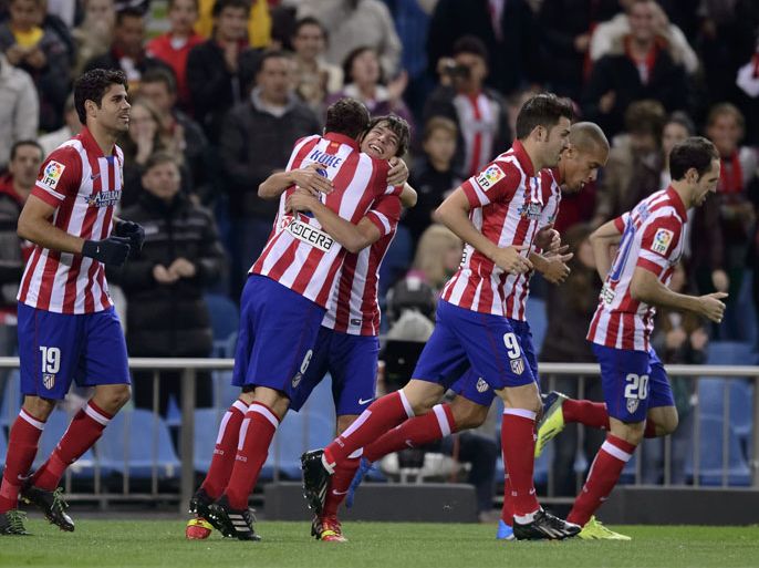 Atletico Madrid's Forward Oliver celebrates with teammates after scoring during the Spanish league football match Club Atletico de Madrid vs Betis at the Vicente Calderon stadium in Madrid on October 27, 2013. AFP PHOTO/ DANI POZO