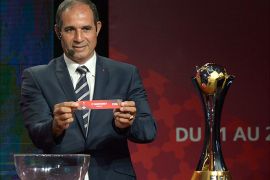 Badou Zaki, former Moroccan goalkeeper and coach, shows the name of Monterrey during the draw for the 2013 Club World Cup in Marrakech on October 9, 2013. Morocco will host this year's tournament with European champions Bayern Munich and Copa Libertadores winners Atletico Mineiro. AFP PHOTO /FADEL SENNA