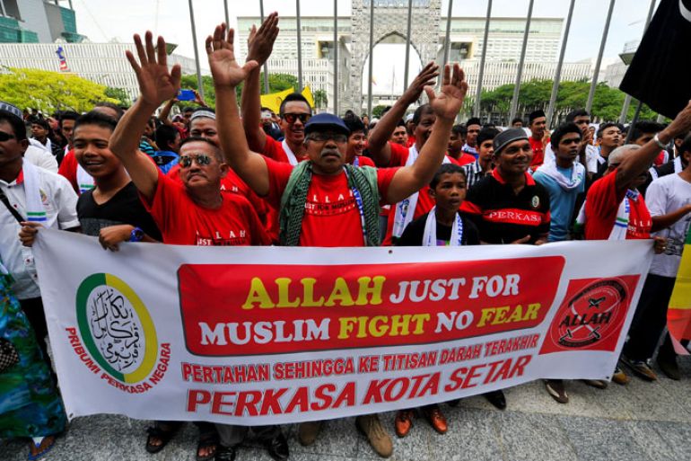 Muslim Protestors display a banner during a demonstration against a Malaysian Catholic newspaper using the word 'Allah' at the court of appeal in Putrajaya, outside Kuala Lumpur on October 14, 2013. An appeals panel ruled on October 14, that a Malaysian Catholic newspaper could not use "Allah" to refer to the Christian god in a case that sparked attacks on churches three years ago.