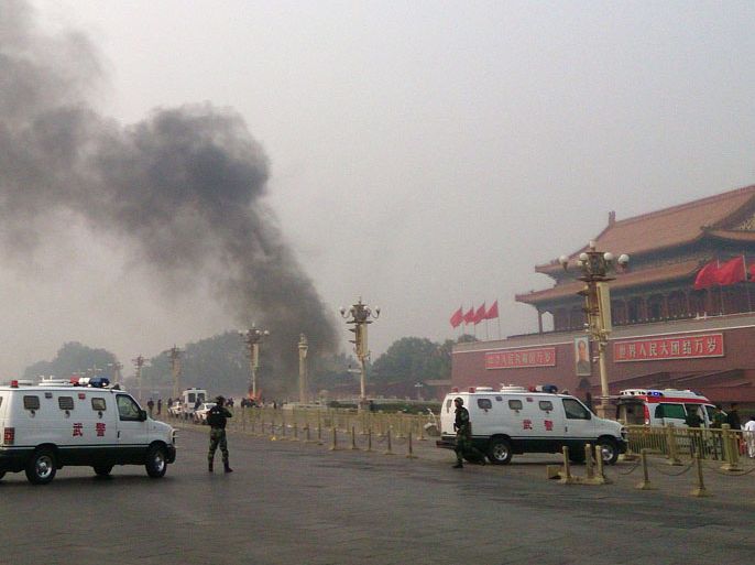 WH2445 - Beijing, -, CHINA : Police cars block off the roads leading into Tiananmen Square as smoke rises into the air after a vehicle crashed in front of Tiananmen Gate in Beijing on October 28, 2013. Three people were killed when an SUV vehicle crashed into a crowd in Beijing's Tiananmen Square and burst into flames, state media said, as pictures showed a tower of smoke rising before the Forbidden City. CHINA OUT AFP PHOTO