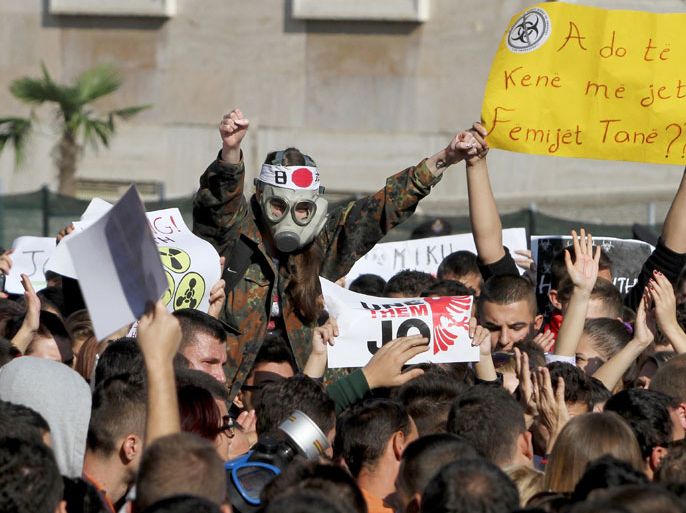 A man wearing a gas mask joins Albanian environmental activists as they take part in a protest in front of the Prime Minister’s office in Tirana on November 15, 2013, over the possibility of the Republic of Albania processing and destroying 1.000 tons of chemical weapons from Syria in its military facilities. Albanian Prime Minister Edi Rama is expected to decide today to accept or not the destruction of Syrian chemical weaponry in Albania. Albania, along with France, Belgium, have been mooted as possible sites for the dismantling of Syria's entire chemical arsenal, estimated at about 1,000 tonnes. AFP PHOTO