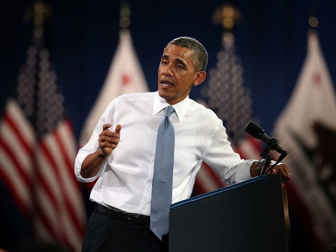 : SAN FRANCISCO, CA - NOVEMBER 25: U.S. President Barack Obama addresses a heckler during a speech at the Betty Ann Ong Chinese Recreation Center on November 25, 2013 in San Francisco, California. President Obama delivered a speech on immigration reform and will attend fundraisers in the San Francisco Bay Area. Justin Sullivan/Getty Images/AFP== FOR NEWSPAPERS, INTERNET, TELCOS & TELEVISION USE ONLY ==