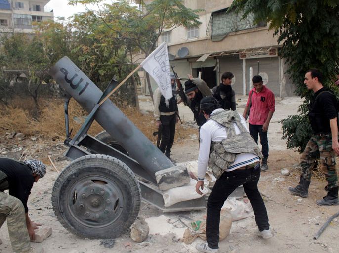 Opposition fighters from the Thu Al-Nurein brigade prepare to fire a homemade cannon in Syria's northern city of Aleppo during clashes with government forces on November 20, 2012. For three weeks, the army has been pressing a campaign to retake rebel-held areas in Aleppo, particularly east of the country's second city, and jihadist fighters have called for mass mobilisation to counter regime advances. AFP PHOTO / NUR HALAB