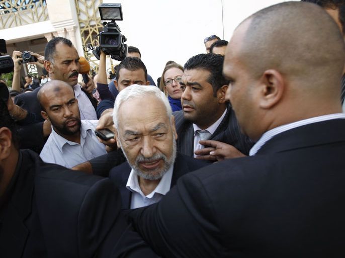 Rached Ghannouchi (C), leader of Ennahda Party, speaks to the media after a meeting, as part of a dialogue between ruling Islamists and the opposition, which aims to pave the way for the formation of a transitional government, in Tunis November 2, 2013. REUTERS/Zoubeir Souissi