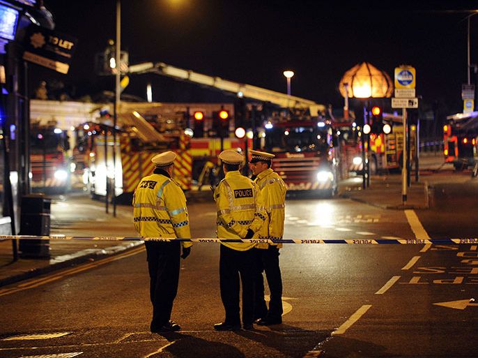 Emergency services gather at the site where a police helicopter crashed into a pub in central Glasgow, Scotland, shortly after midnight on November 30, 2013