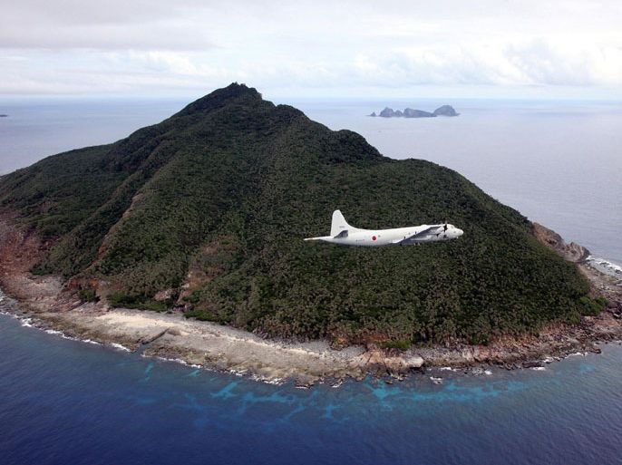 Senkaku, Okinawa, JAPAN : This photo taken on October 13, 2011 shows a P-3C patrol plane of Japanese Maritime Self-Defense Force flying over the disputed islets known as the Senkaku islands in Japan and Diaoyu islands in China, in the East China Sea. Japanese military and paramilitary planes have flown through China's newly declared air zone without any resistance from Chinese jets, an official and a report said on November 28, 2013. AFP PHOTO / JAPAN POOL via JIJI PRESS JAPAN OUT