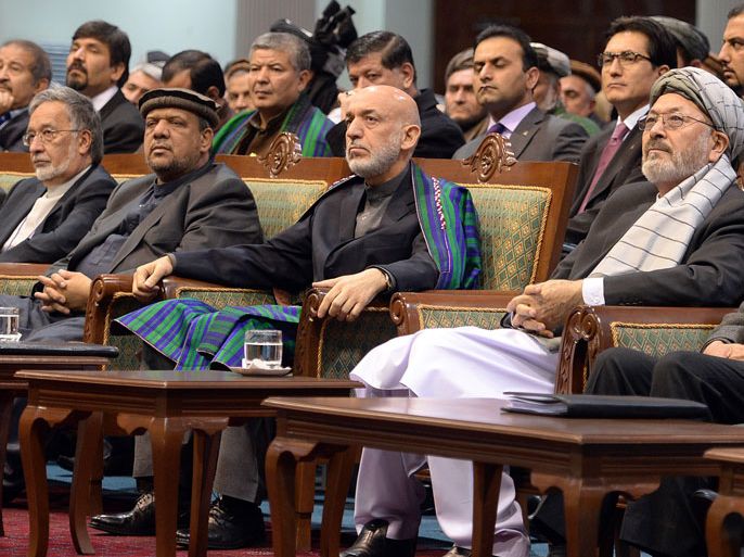 MH1827 - Kabul, -, AFGHANISTAN : Afghan President Hamid Karzai attends the Afghan loya jirga, a meeting of around 2,500 Afghan tribal elders and leaders, on the last day of the four-day long loya jirga in Kabul on November 24, 2013. An Afghan grand assembly endorsed a crucial security agreement allowing some US troops to stay on after 2014, although President Hamid Karzai set conditions for signing the deal. AFP PHOTO/Massoud HOSSAINI