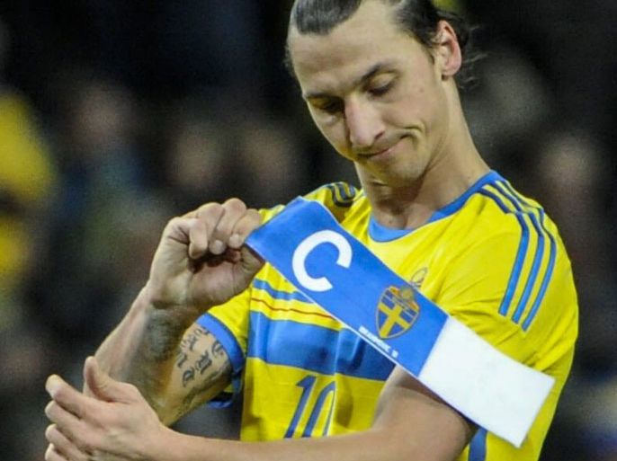 : Sweden's forward Zlatan Ibrahimovic takes off his captain band at the Friends Arena in Solna, near Stockholm on November 19, 2013 after the FIFA 2014 World Cup playoff football match Sweden vs Portugal. Sweden lost 2-3. AFP PHOTO/ TT NEWS AGENCY/ ERIK MARTENSSON /SWEDEN OUT