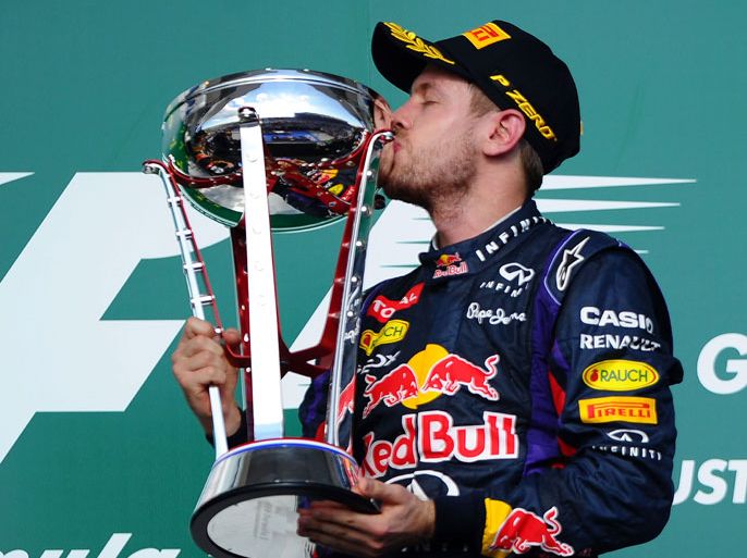 Red Bull Racing's German driver Sebastian Vettel kisses the trophy after winning the United States Formula One Grand Prix at Circuit of The Americas on November 17, 2013 in Austin, Texas. AFP Photo/Jewel Samad