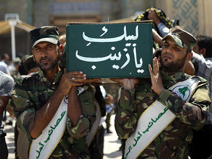 Members of the Iraqi Shiite militia, Asaib Ahl Al-Haq, carry the coffins of their comrades who were reportedly killed in the fight in Syria against the Free Syrian Army, during the funeral processions in Najaf, south of Iraq, 22 August 2013. According to media reports, hundreds of the Shiite Iraqi militia had allegedly joined to fight with the Syrian government forces against the Free Syrian Army. EPA/KHIDER ABBAS