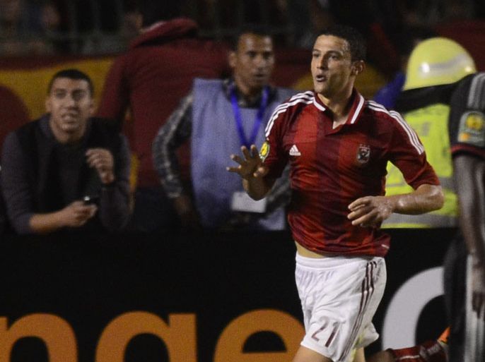 Egypt's al-Ahly's football player, Ahmed Abdul Zaher shows a four-finger sign, called Rabaa (four) in Arabic, as he celebrates after scoring during the African Champions League second leg final against South Africa's Orlando Pirates in Cairo on November 10, 2013. Al-Ahly decided to suspend Ahmed Abdul Zaher from next month's FIFA Club World Cup in Morocco after he did the four-finger sign that has been associated with the crackdown on supporters of ousted Islamist president in Cairo's Rabaa al-Adawiya square. AFP PHOTO / MOHAMED HISHAM ====EGYPT OUT