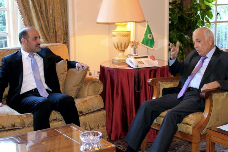 Arab League general secretary Nabil al-Arabi (R) meets with the Syrian opposition chief Ahmed Jarba in Cairo on November 26, 2013. Syria's main opposition National Coalition insisted that President Bashar al-Assad should play no role in the country's political future, while hailing the fixing of a date for peace talks. AFP PHOTO